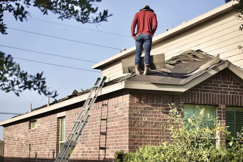 Professional roofer working on a residential roof in Silverwood Plantation